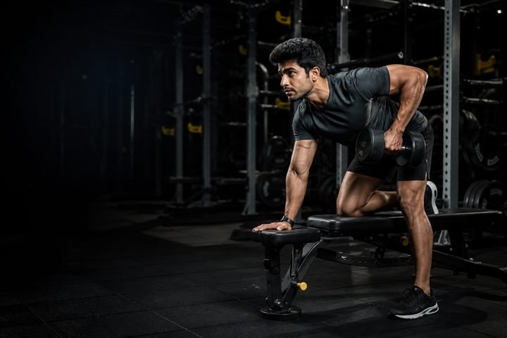 Athlete training in a premium dark fitness studio website concept
